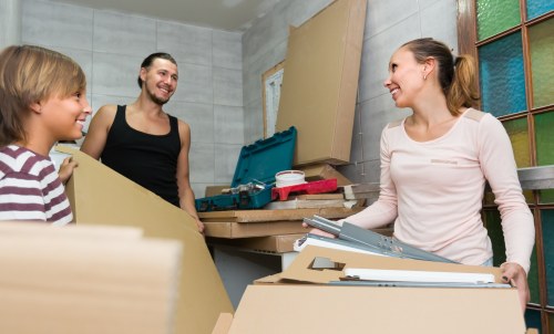 Removal team handling flat removals in Ealing with boxes and furniture