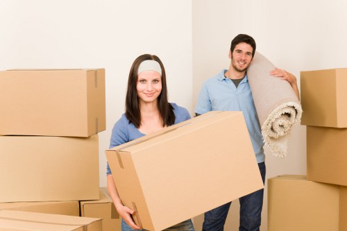 Packed office boxes and furniture ready for removal in Ealing