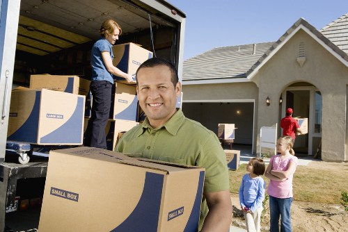 Packing boxes and furniture into a storage unit in Ealing